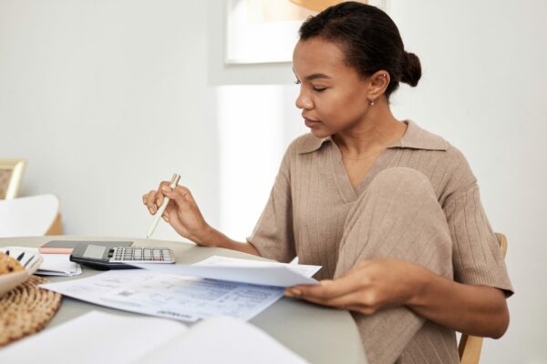 Young Black Woman Doing Taxes At Home And Using Ca 2023 11 27 05 04 42 Utc Copy Scaled